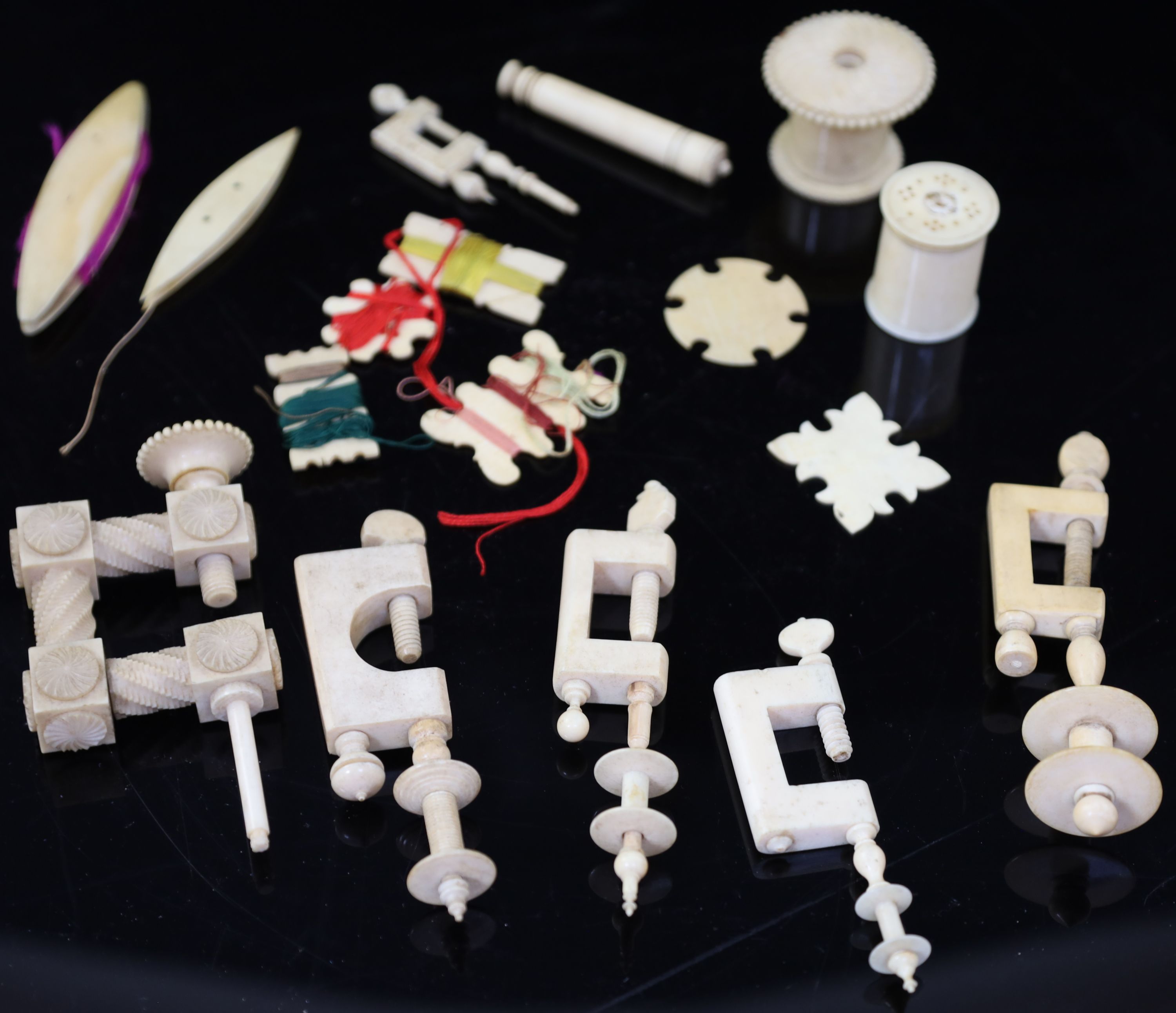 A collection of assorted early 19th century and later ivory sewing accessories